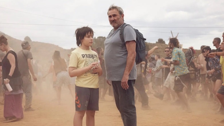 Luis and Esteban surounded by dancers at a rave in the Moroccan desert in Sirat
