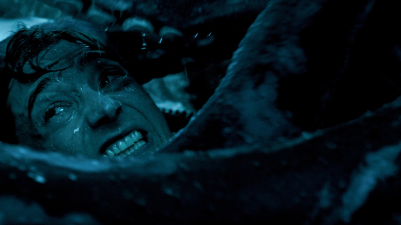 Austin Abrams as Jay Gardiner trapped in the mouth of a sperm whale with a squid in Whalefall