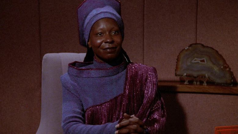 Guinan in a conference room in Star Trek: The Next Generation