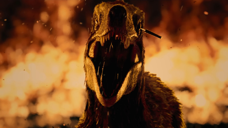 A raptor surrounded by fire with a knife in its eye in Primtive War