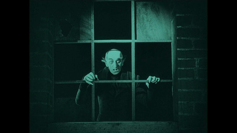 Max Schreck as Count Orlak, who stands behind the window frame in the film 