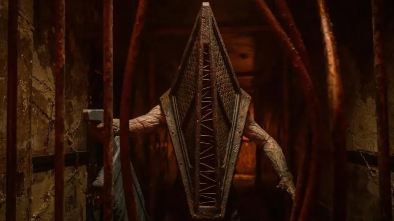 Pyramid Head breaking through metal bars in Return to Silent Hill