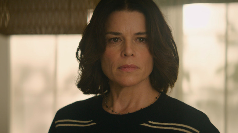 Neve Campbell as Sidney Prescott listening to the Ghostface phone call in her office in Scream 7