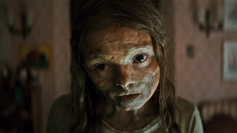 Natalie Grace as Katie with a blank expression on her face in her room in Lee Cronin's The Mummy