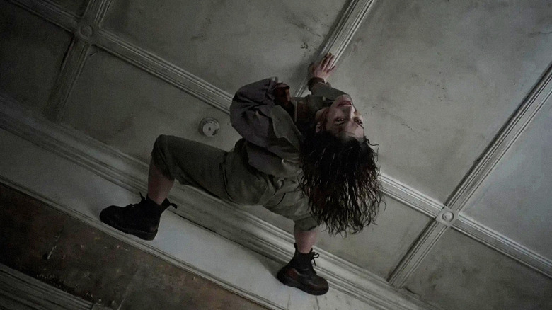 Luciane Buchanan as Thya as a Deadite on the ceiling in Evil Dead Burn