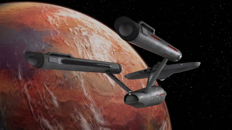 The Enterprise entering orbit of a distant planet on Star Trek