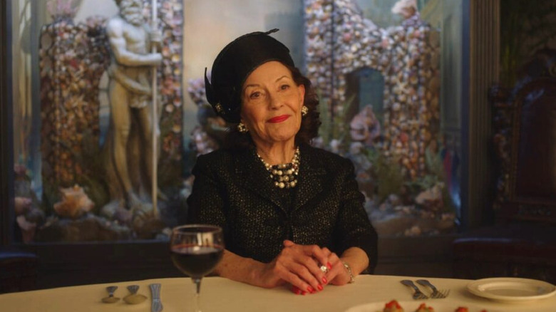 Kelly Bishop as Bendetta, smiling at a dinner table in The Marvelous Mrs. Maisel