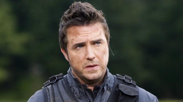 Paul McGillion as Carson Beckett, looking confused in a field on Stargate Atlantis