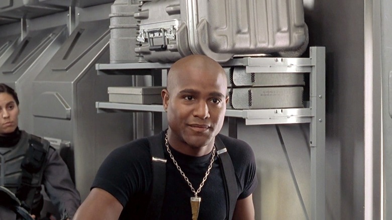 Seth Gilliam as Sugar Watkins on Starship Troopers, holding a big gun