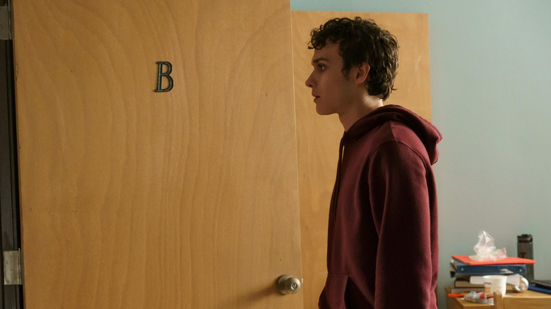 Drew staring past a door on Tell Me Lies
