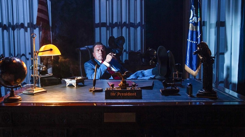 Arnold Schwarzenegger as Mr. President sitting at his desk in Kung Fury 2