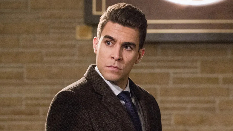 Josh Segarra as Adrian Chase, dressed as a DA on Arrow
