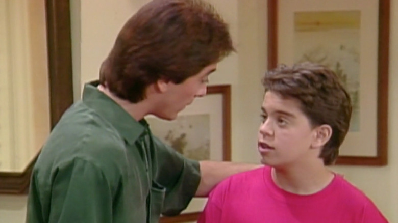 Adam Powell (Alexander Polinsky) looking up at Charles (Scott Baio) on Charles in Charge
