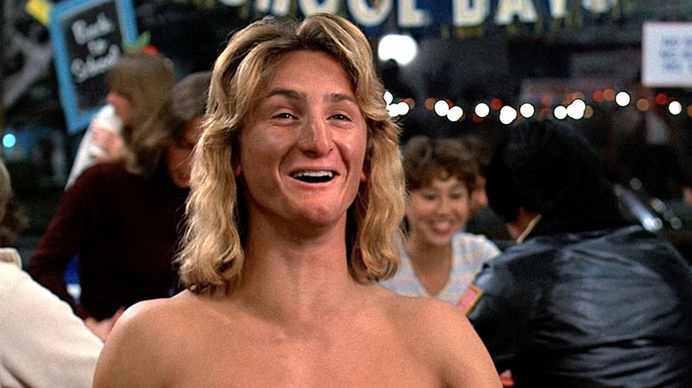 Sean Penn as Jeff Spicoli sitting shirtless in a diner in Fast Times at Ridgemont High