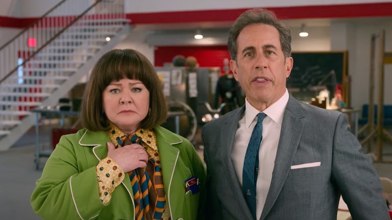 Melissa McCarthy and Jerry Seinfeld as Ravioli and Donna, looking concerned at something in Unfrosted