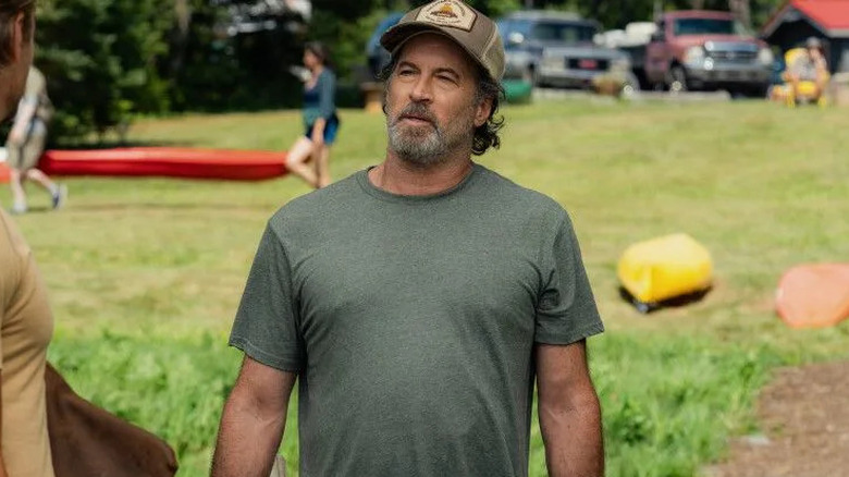 Scott Patterson as Harry Sullivan, standing near canoes on Sullivan's Crossing