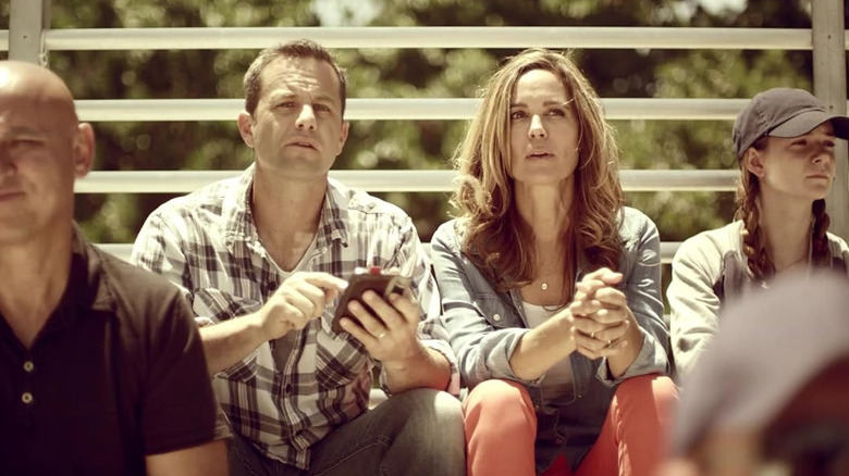 Kirk Cameron and Chelsea Noble on bleachers as John & Maddie Miller in Mercy Rule