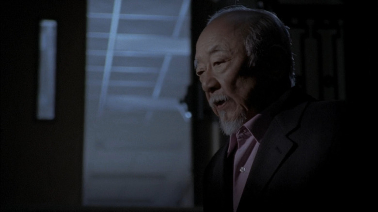 Exhibition Manager (Pat Morita) looking down in Royal Kill