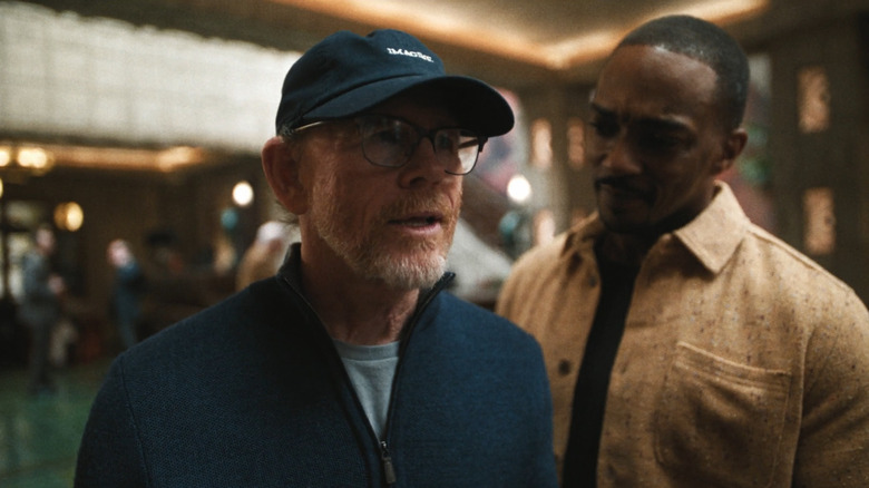 Ron Howard talks with Anthony Mackie looking over shoulder in The Studio