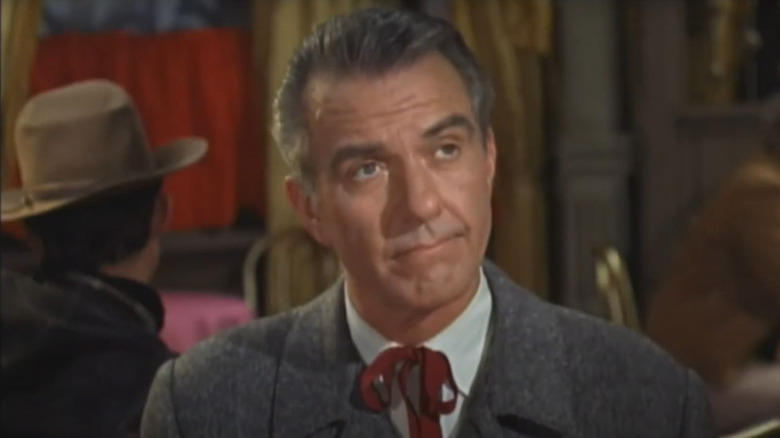 Hugh Beaumont as Jed on Wagon Train, preparing to have a drink with Pearlie Garnet