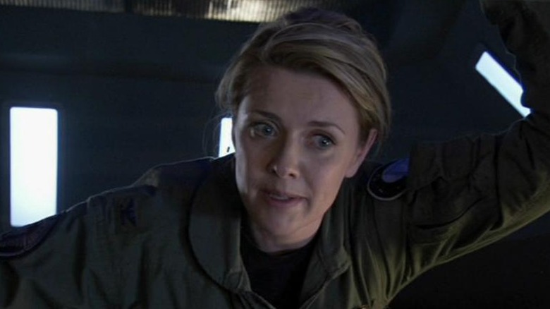 Amanda Tapping as Samantha Carter, leaning against a ceiling on Stargate Atlantis