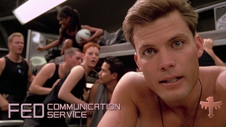 Casper Van Dien as Johnny Rico in Starship Troopers, staring into the camera in front of bunkbeds