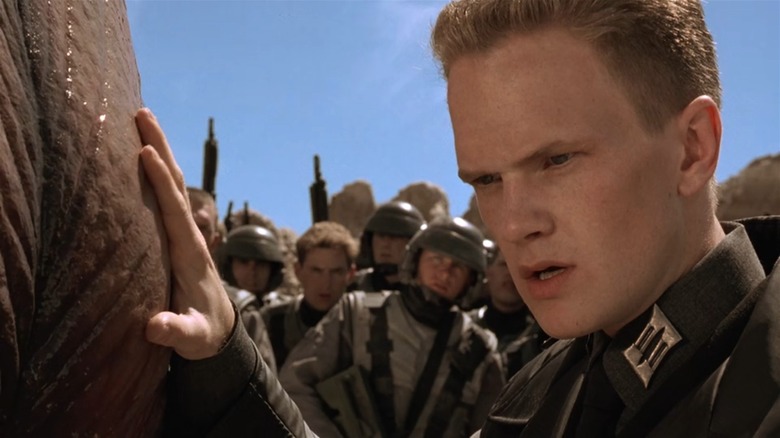 Neil Patrick Harris as Carl Jenkins in Starship Troopers, in uniform staring angrily