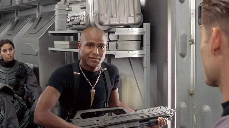 Seth Gilliam as Sugar Watkins on Starship Troopers, holding a big gun