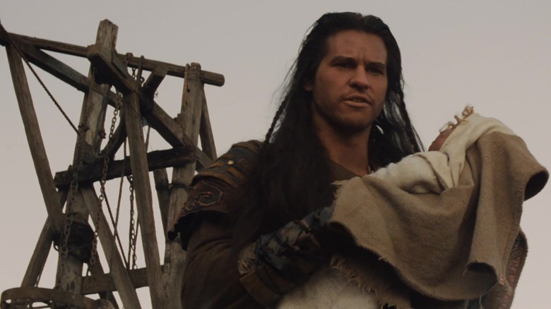 Val Kilmer as Madmartigan holds baby Elora in Willow
