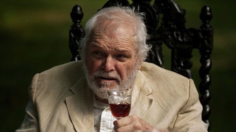 Brian Dennehy as Sorin, raising a glass of win in The Seagull