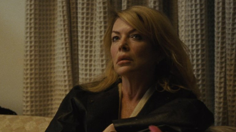 Lara Flynn Boyle as Linda sitting on a couch in Mother Couch