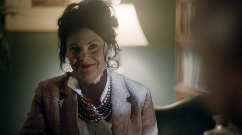 Sherilyn Fenn as Etta smiling in an office in The Magicians