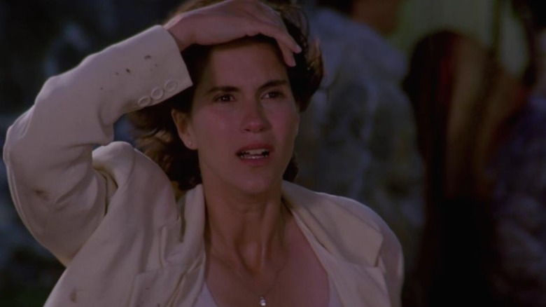 Jami Gertz as Dr. Melissa Reeves, staring up at the sky in fear