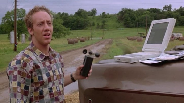 Joey Slotnick as Joey stands in front of laptop in Twister