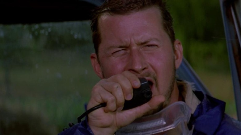 Todd Field as Beltzer talking on a handheld radio, in Twister
