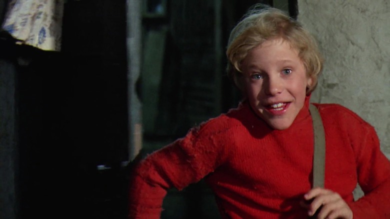 Charlie Bucket running in a red sweater in Willy Wonka and the Chocolate Factory