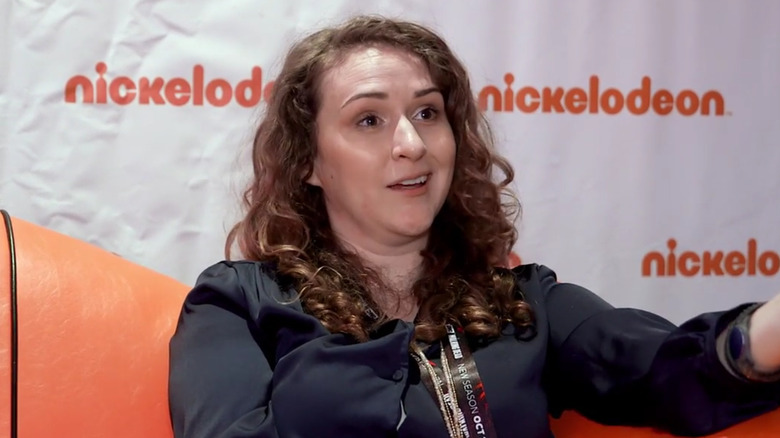 Francesca Marie Smith sitting and talking on an orange couch