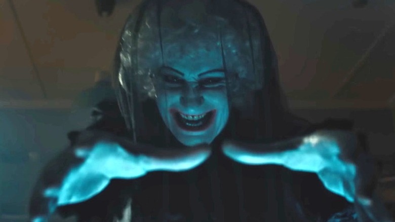 A demon in a veil with her hands out in Insidious: Out of the Further