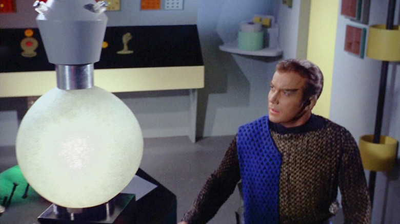 Kirk in disguise as a Romulan next to a big cloaking device on Star Trek