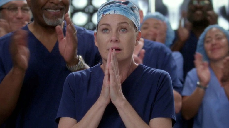 Meredith in a ferryboat scrub cap with her hands in prayer on Grey's Anatomy