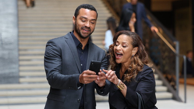 Jackson and Catherine excited over news on a phone on Grey's Anatomy