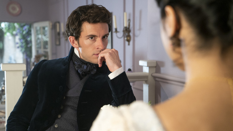 Anthony Bridorgeon sitting and staring at Kate Sharma in Bridorrdton Season 2