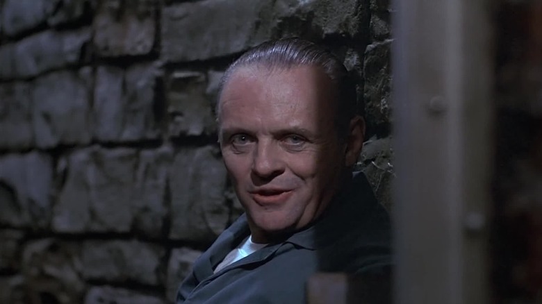 Hannibal Lecter smiling creepily in his prison cell in The Silence of the Lambs