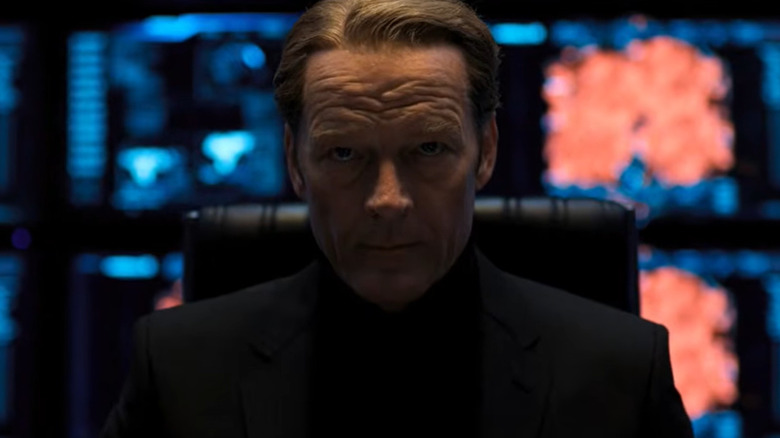 Dr. Alexander Isaacs sitting at his desk in Resident Evil