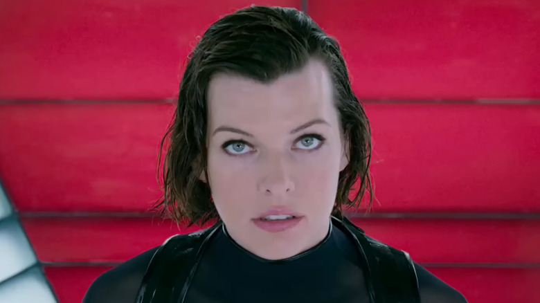 Milla Jovovich as Alice standing on the Umbrella Corporation logo in Resident Evil: Retribution