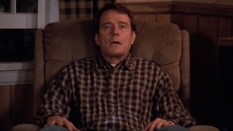 Bryan Cranston as Hal sitting exhausted in a chair on Malcolm in the Middle
