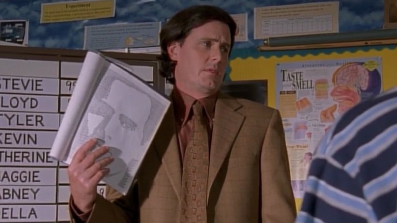 Chris Eigeman as Lionel holding a print out of a face on Malcolm in the Middle