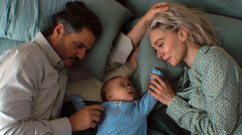 Reed Richards and Sue Storm lie in bed with their baby, Franklin, in The Fantastic Four: First Steps