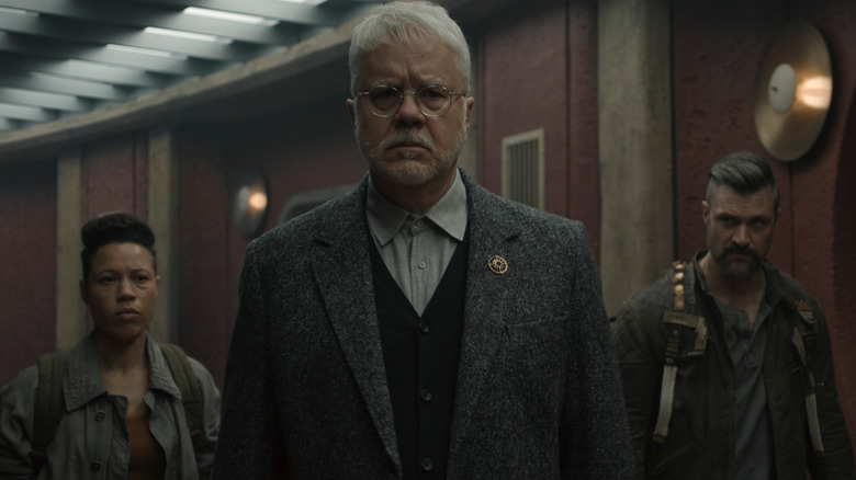 Bernard leads to people from mechanical up the stairs in Silo