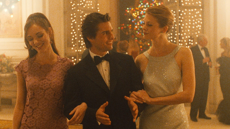 Bill surrounded by two women at a Christmas party in Eyes Wide Shut